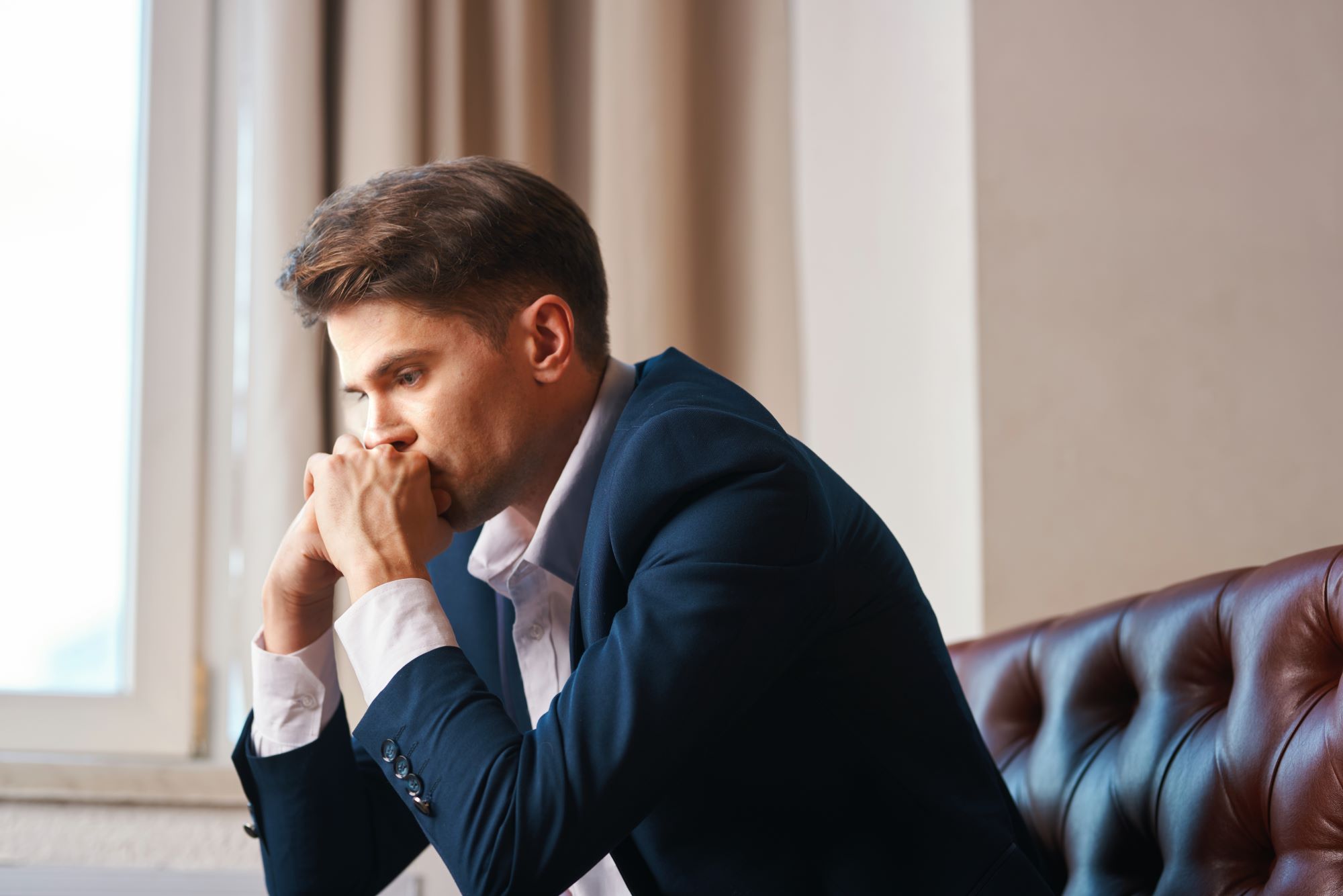 Young lawyer waits in the lobby at Blair Wellness Group for his relationship counseling appointment.