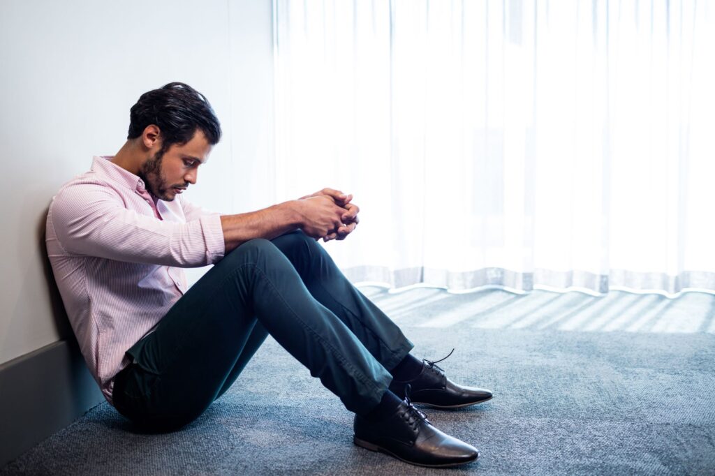 Lonely business leader sits on floor before his therapy appointment in Beverly Hills