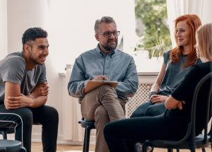 Smiling,Spanish,Man,Talking,To,His,Friends,During,Meeting,For